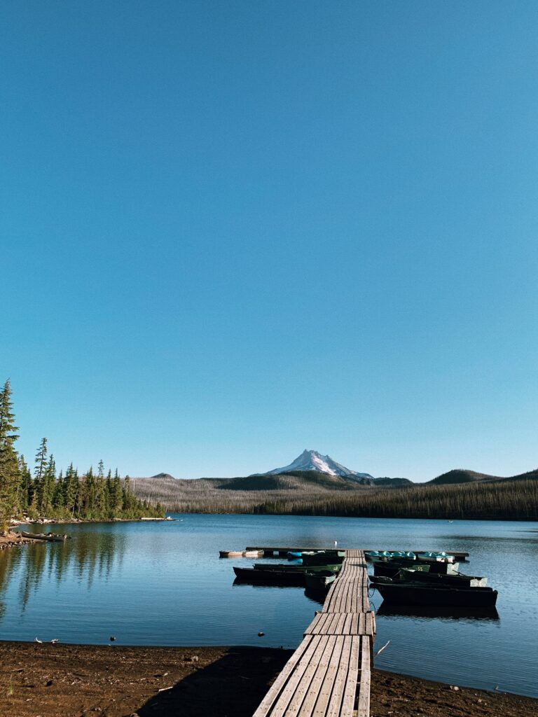 Dock stretching into blue lake with Mt. Jefferson in the background