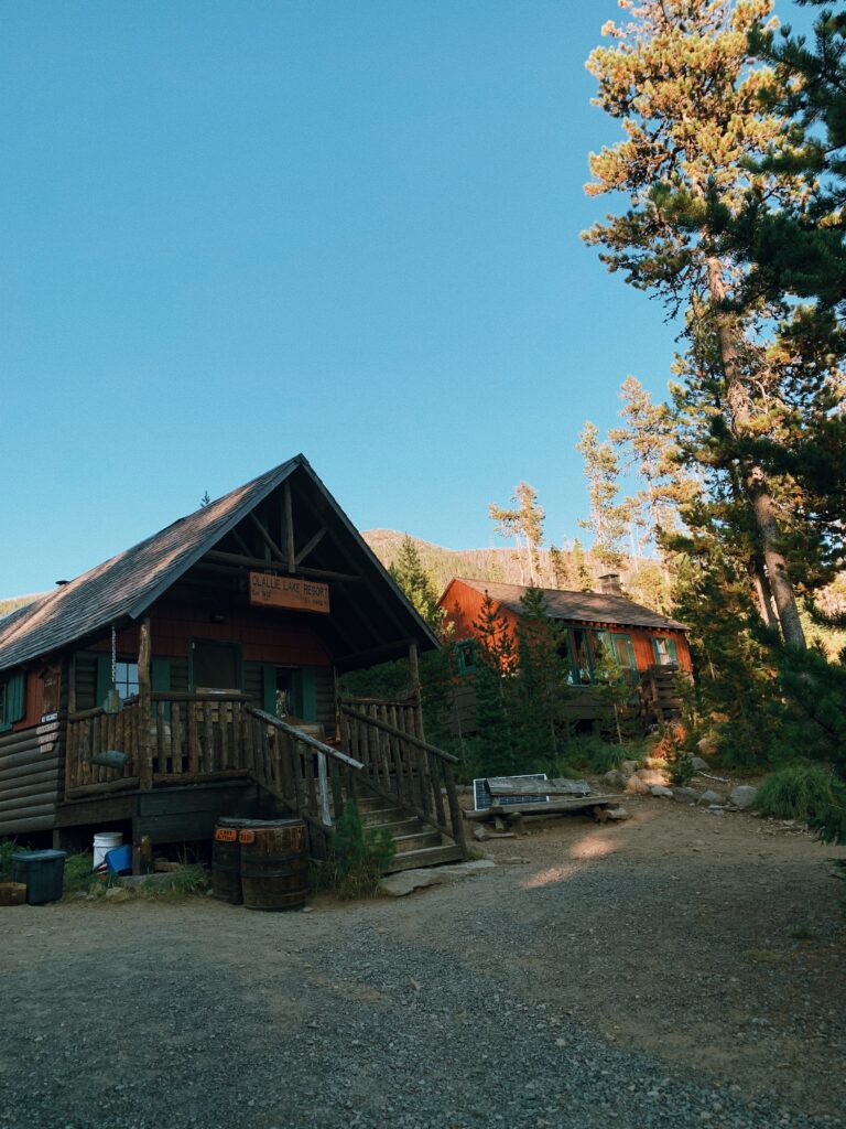 Small wooden building beneath a blue sky in the woods